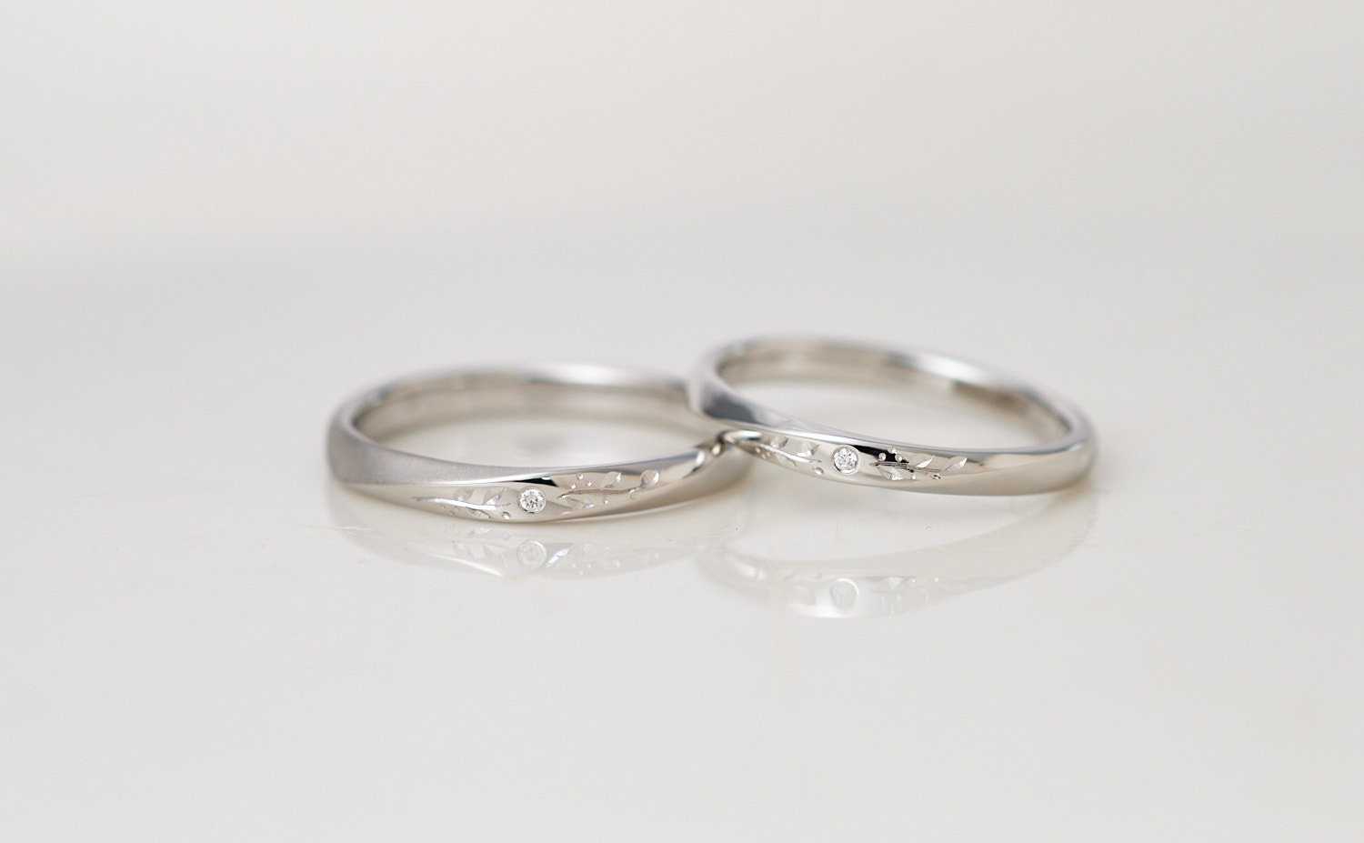 草花彫りとダイヤモンドが輝く捻りのプラチナ結婚指輪